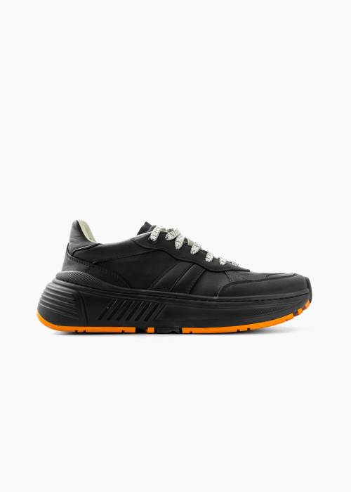 Black sneakers with orange sole