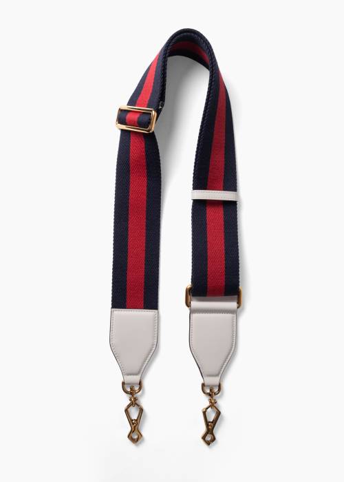 Bandoulière en toile Web avec des détails en cuir blanc et une quincaillerie dorée.