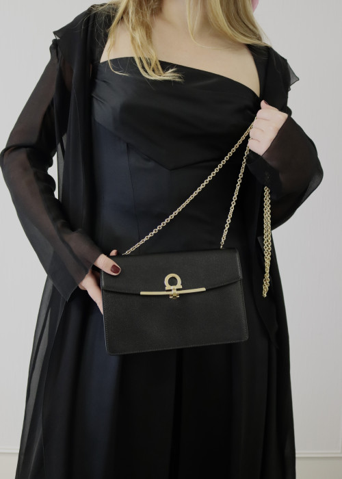 Black leather bag with gold jewellery