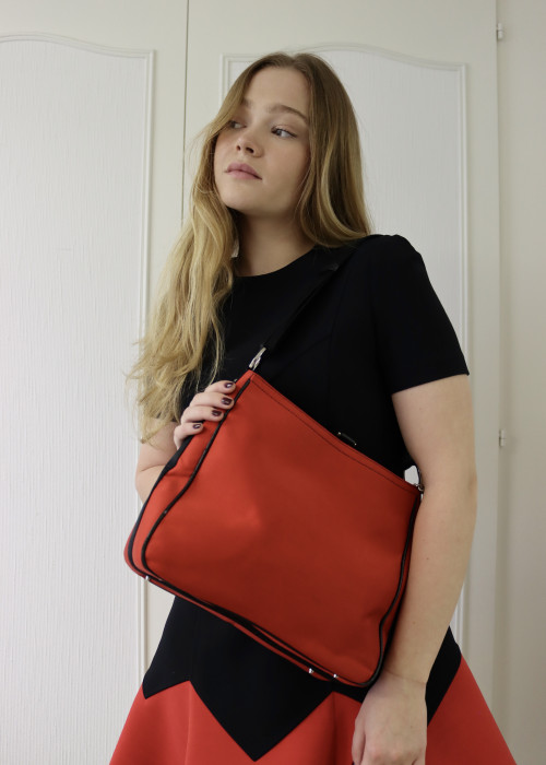 Red fabric and black leather bag