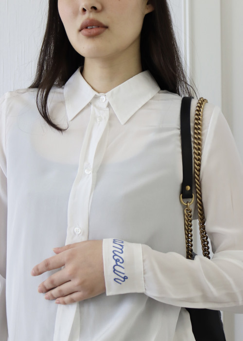White shirt with "amour" embroidered in blue