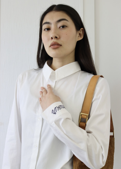 White shirt with "amour" embroidered in black