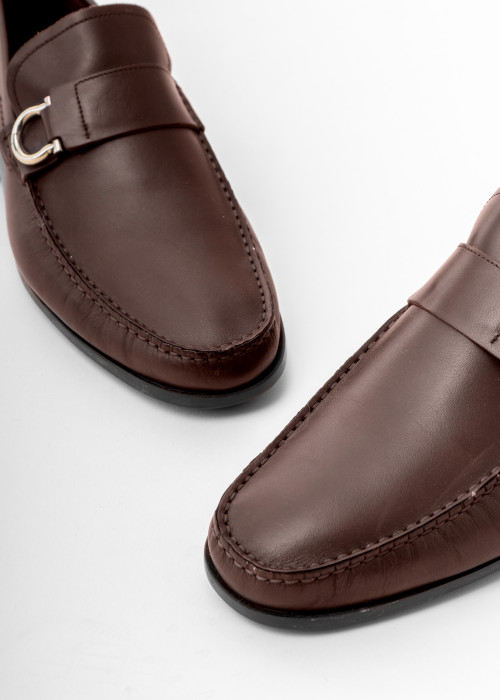 Brown leather loafers with silver buckle
