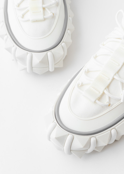 White sneakers with spiked sole