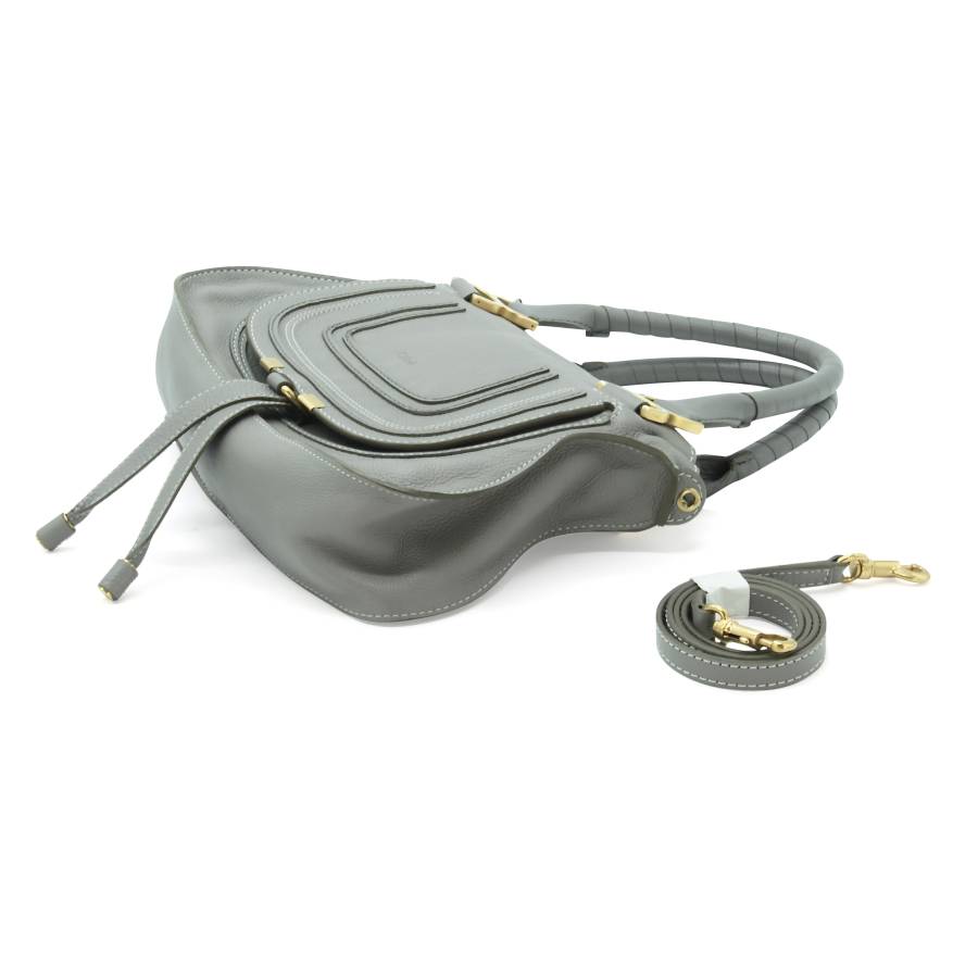 Grey leather bag with gold jewelry