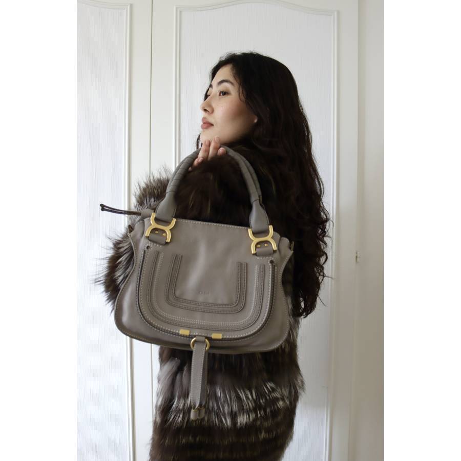 Grey leather bag with gold jewelry