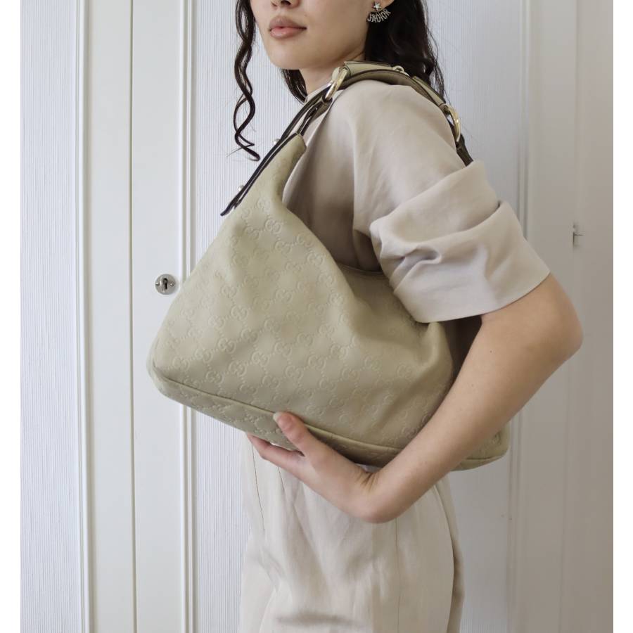 Beige leather bag with gold jewellery
