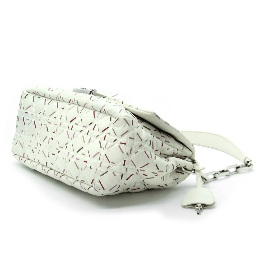White leather bag with red and pink touches