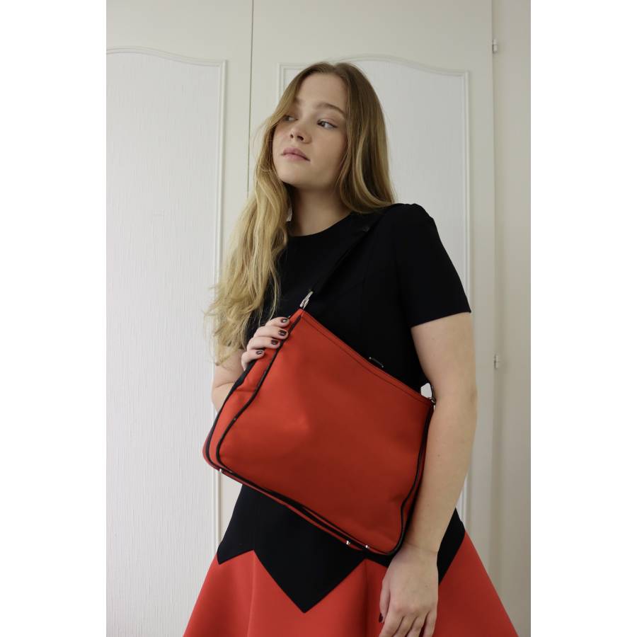 Red fabric and black leather bag