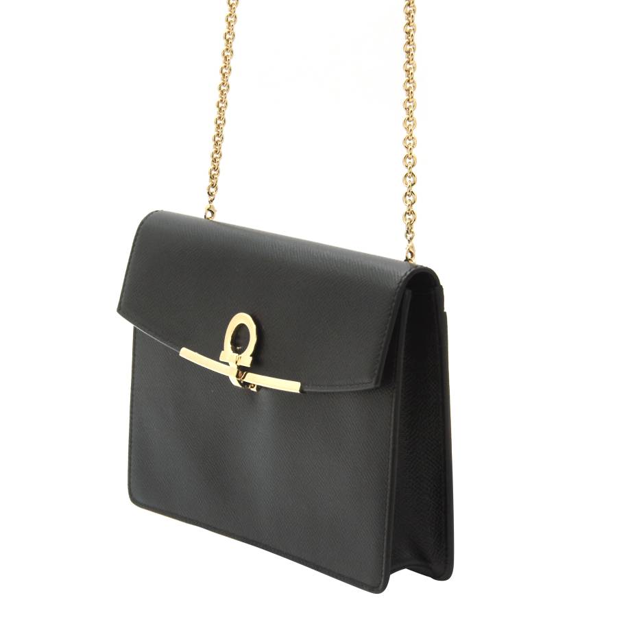 Black leather bag with gold jewellery