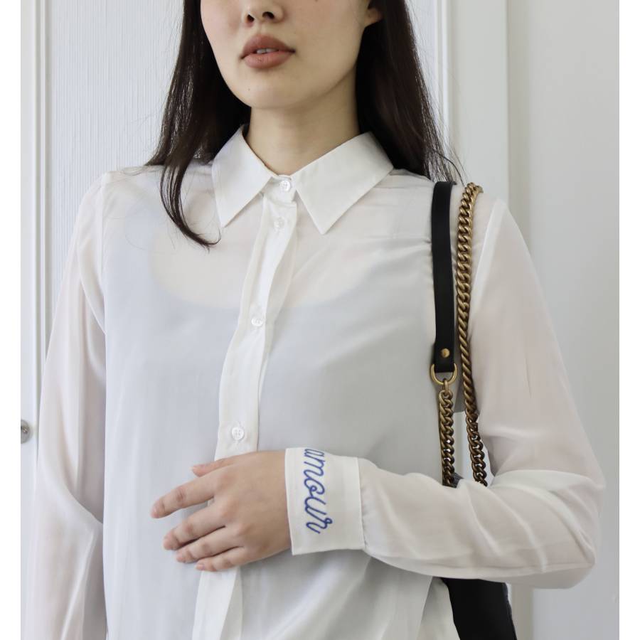 White shirt with "amour" embroidered in blue