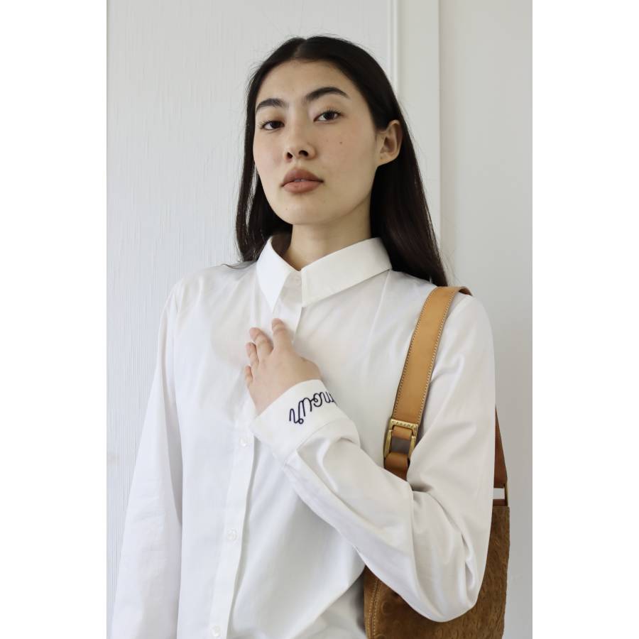 White shirt with "amour" embroidered in black