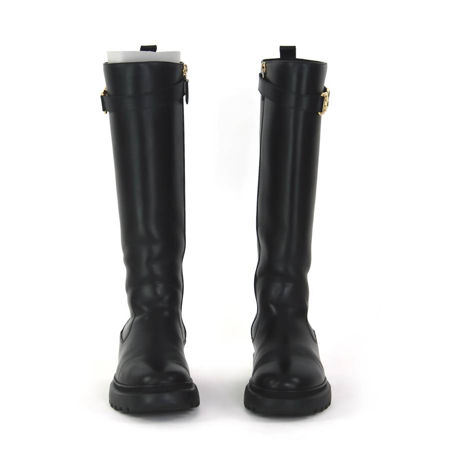 High boots in black leather with gold buckles