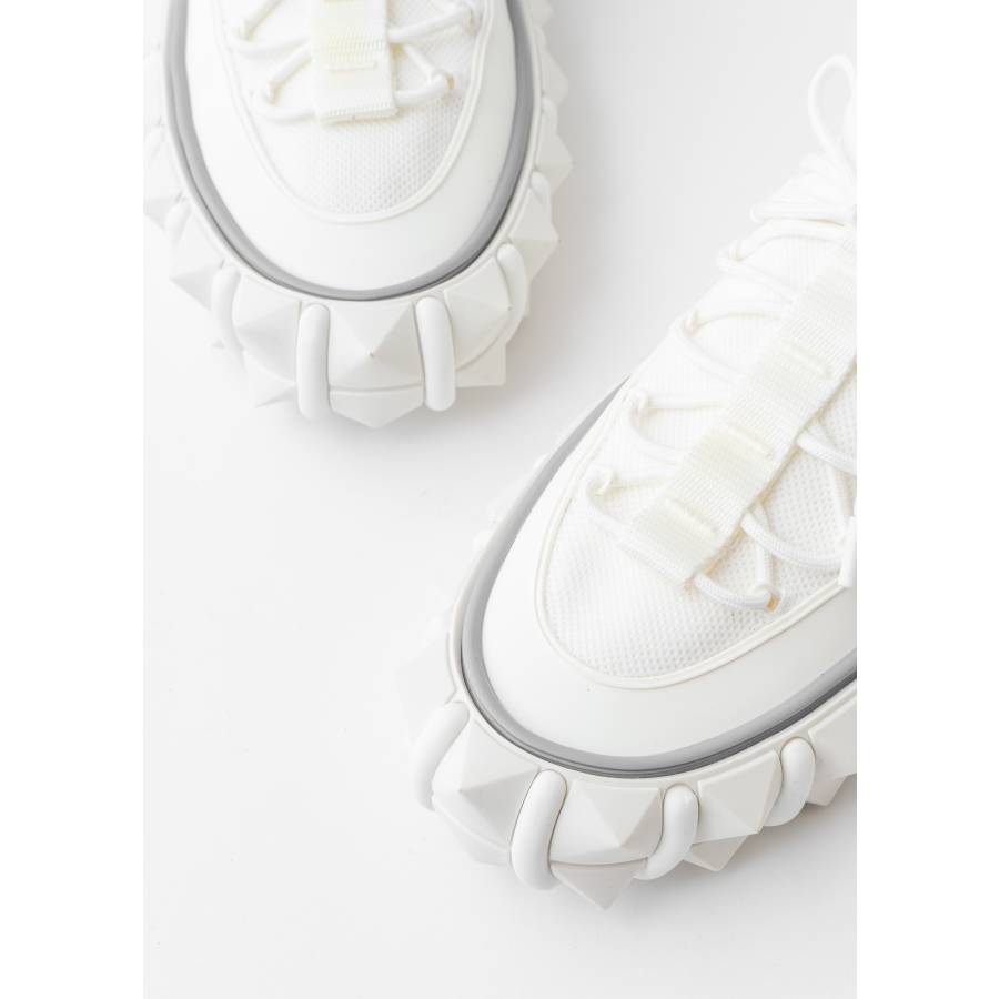 White sneakers with spiked sole