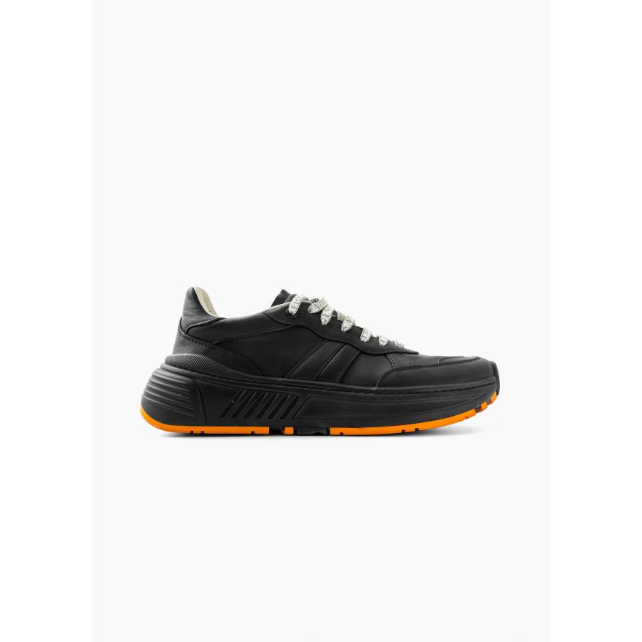 Black sneakers with orange sole