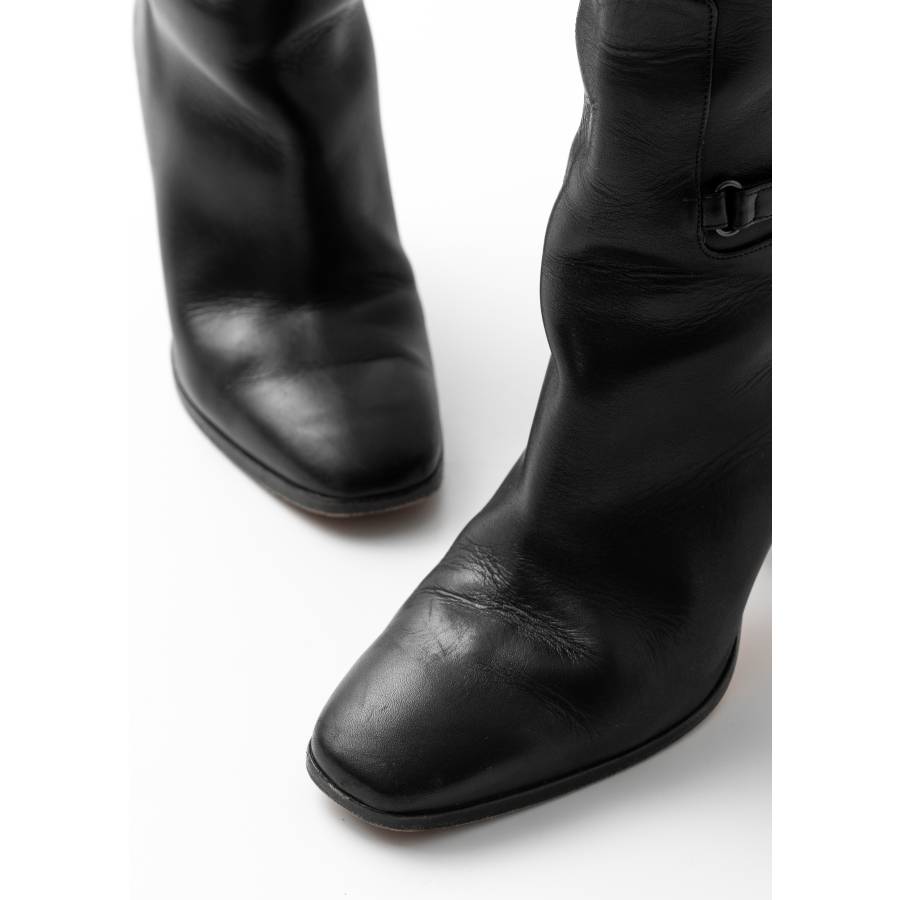 Black leather boots with straps